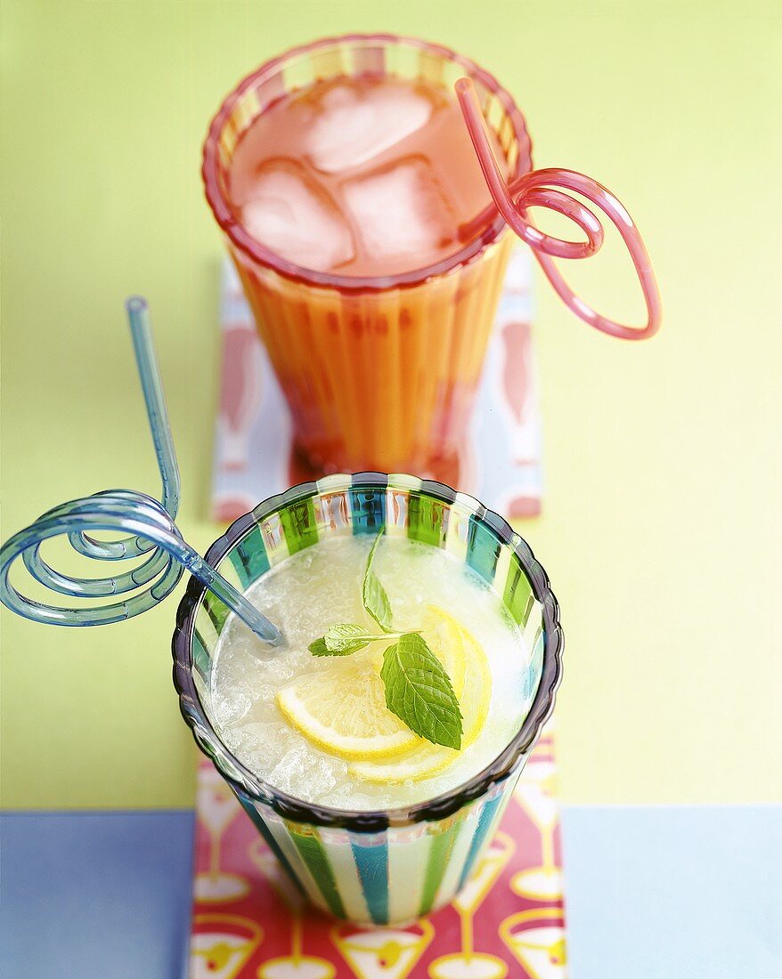 Ice-cold lemonade and pink grapefruit juice in glasses