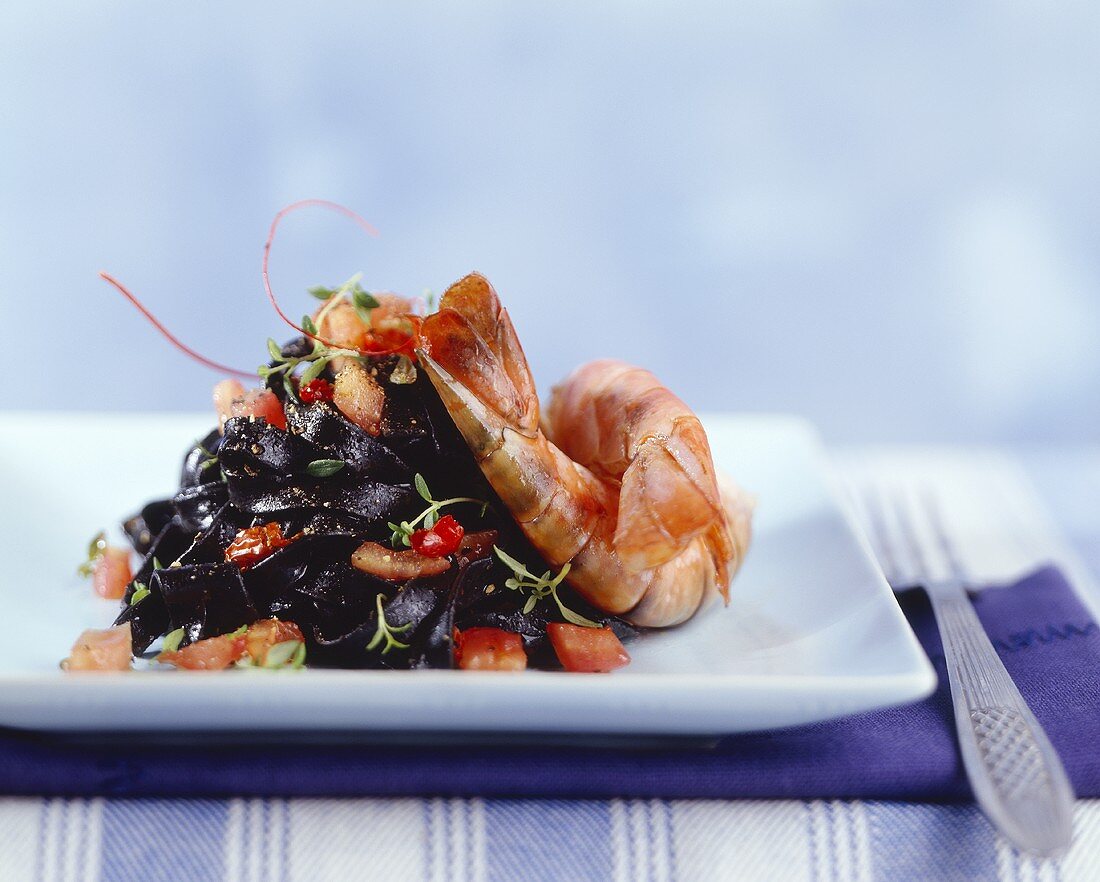 Shrimps with tomatoes and garlic and black noodles