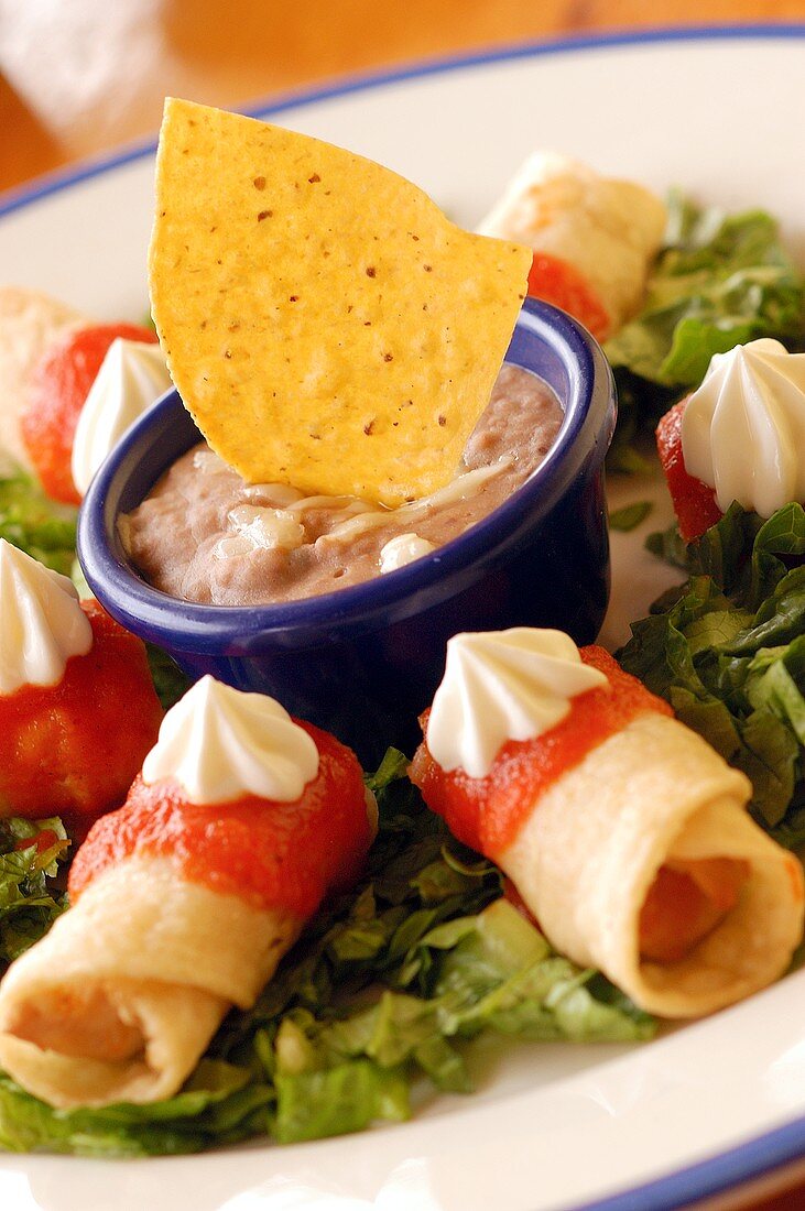 Flautas (crispy Mexican tortilla rolls) with dip