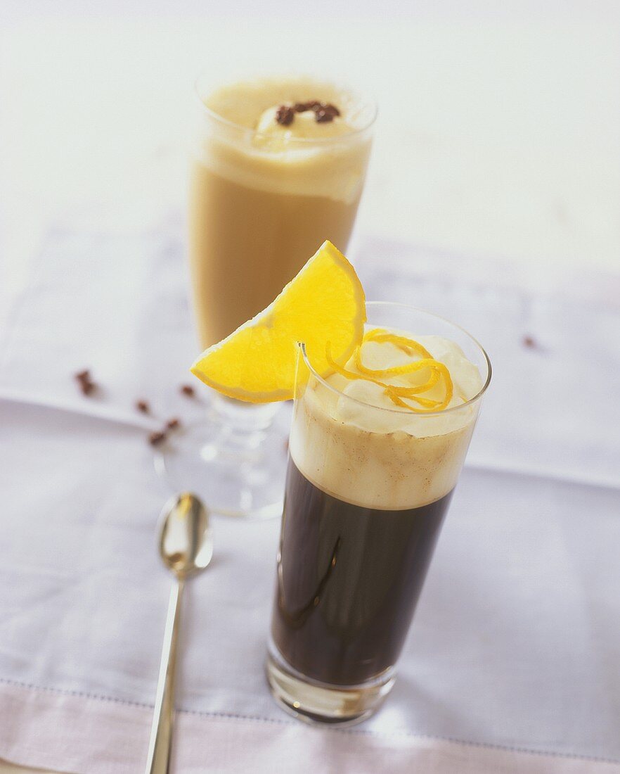 Orange coffee and coffee punch (in background) in glass