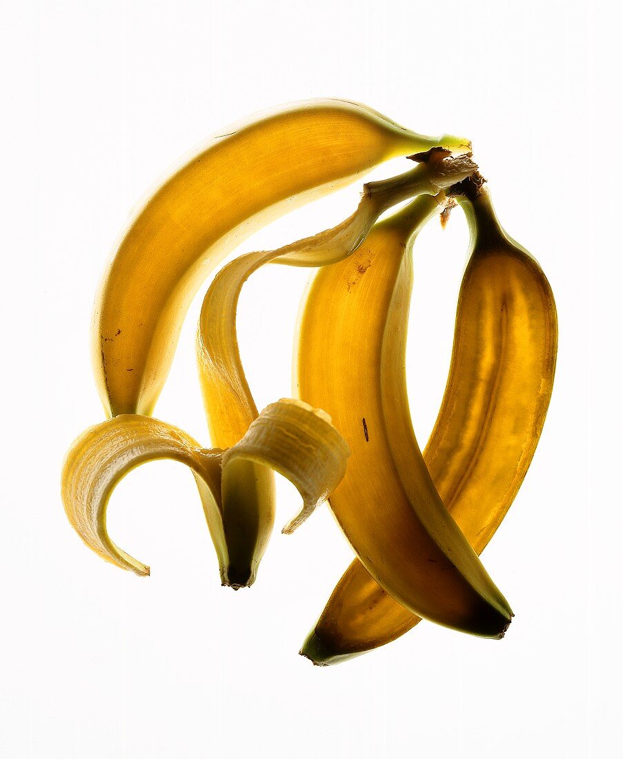 Three bananas and a banana skin