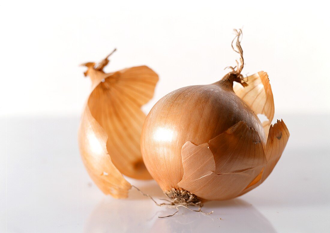 An onion with outer layer of peel removed