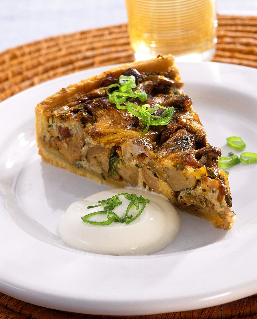 A piece of mushroom quiche on a plate