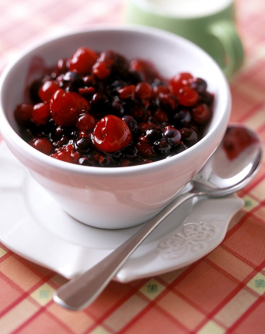 Red fruit compote in a white bowl