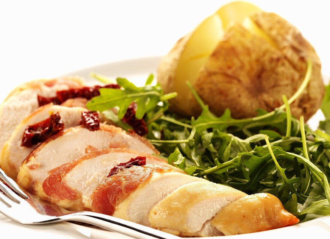 Chicken breast wrapped in bacon with rocket salad & potato