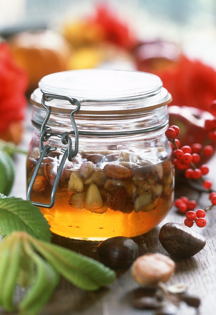 Honey with chestnuts and almonds in jar