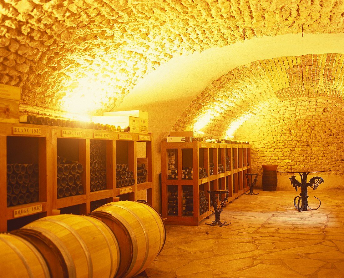 Bottles and barrels stored in wine cellar, Vouvray, Loire