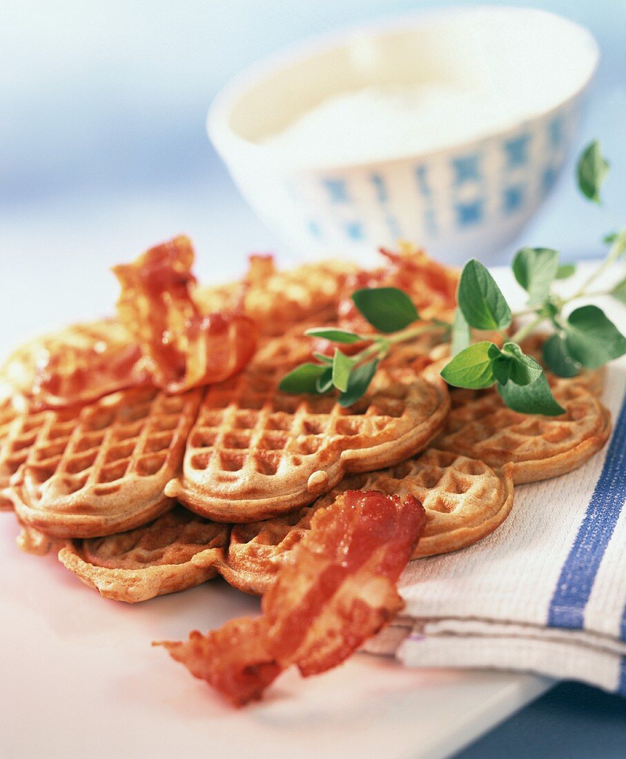 Buckwheat and bacon waffles and bowls of soft cheese dip