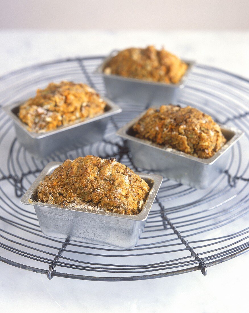 Four small vegetable and nut loaves in loaf tins
