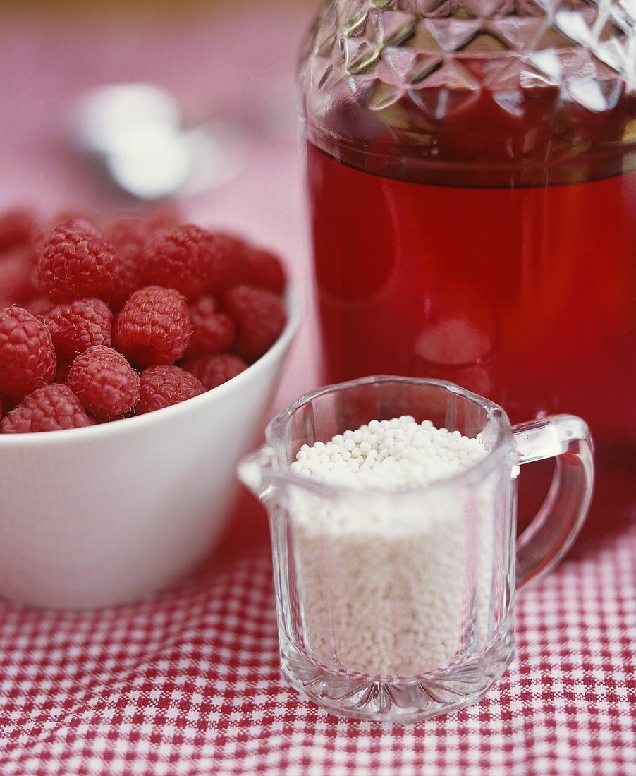 Ingredients for red berry compote (juice, barley, raspberries)
