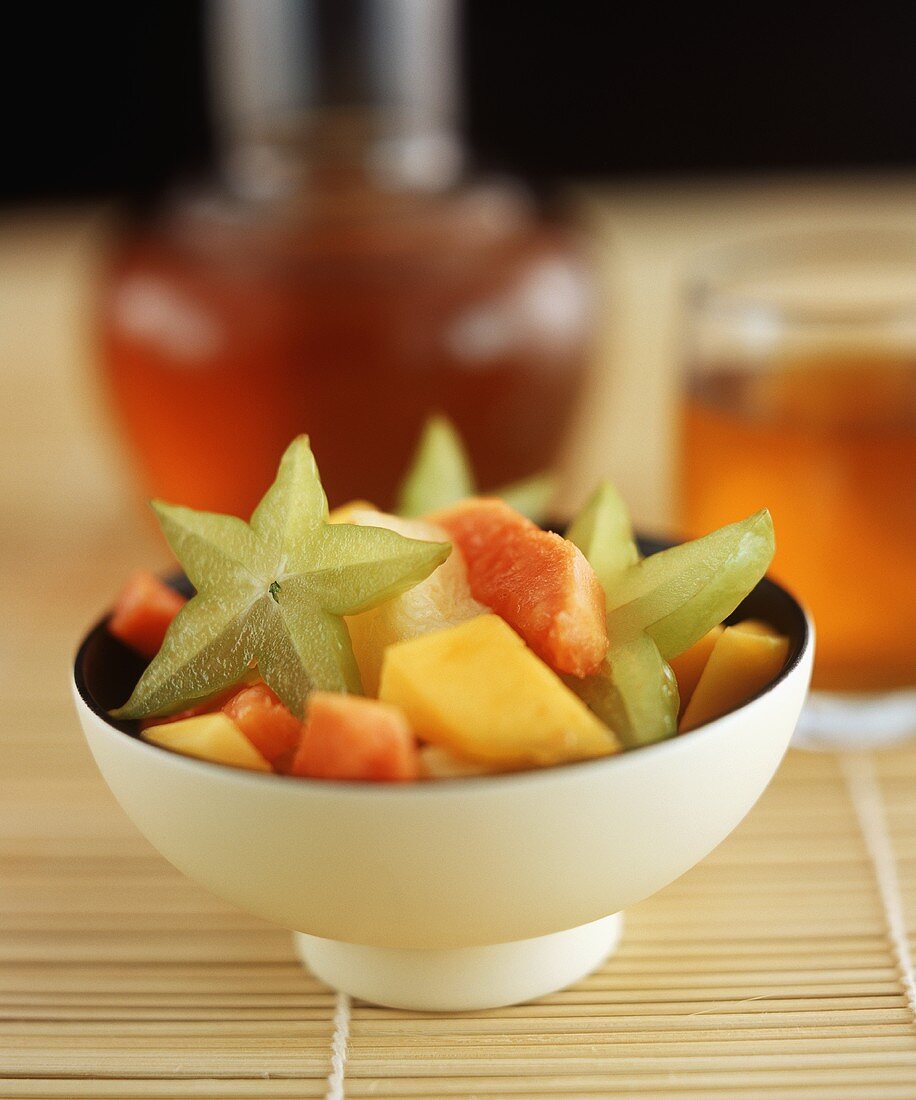 Fruit salad with carambola stars in bowl