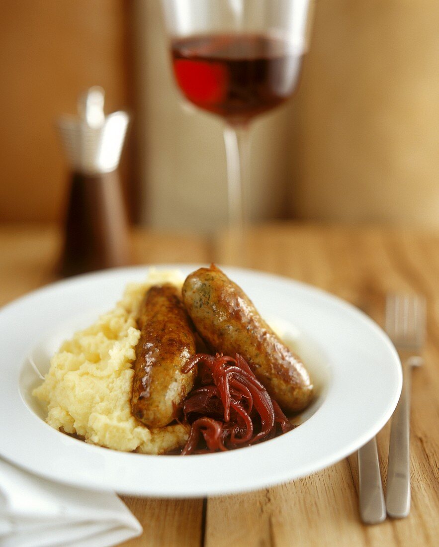 English sausages with mashed potato and red onions