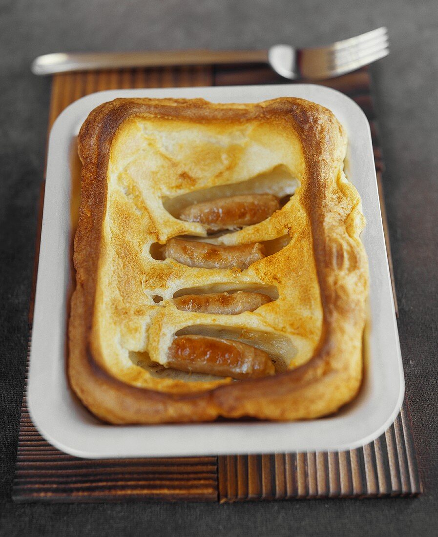 Toad in the hole (sausages baked in batter; England)