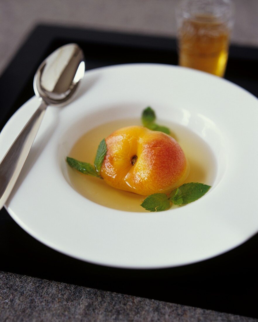 Poached peach in white wine