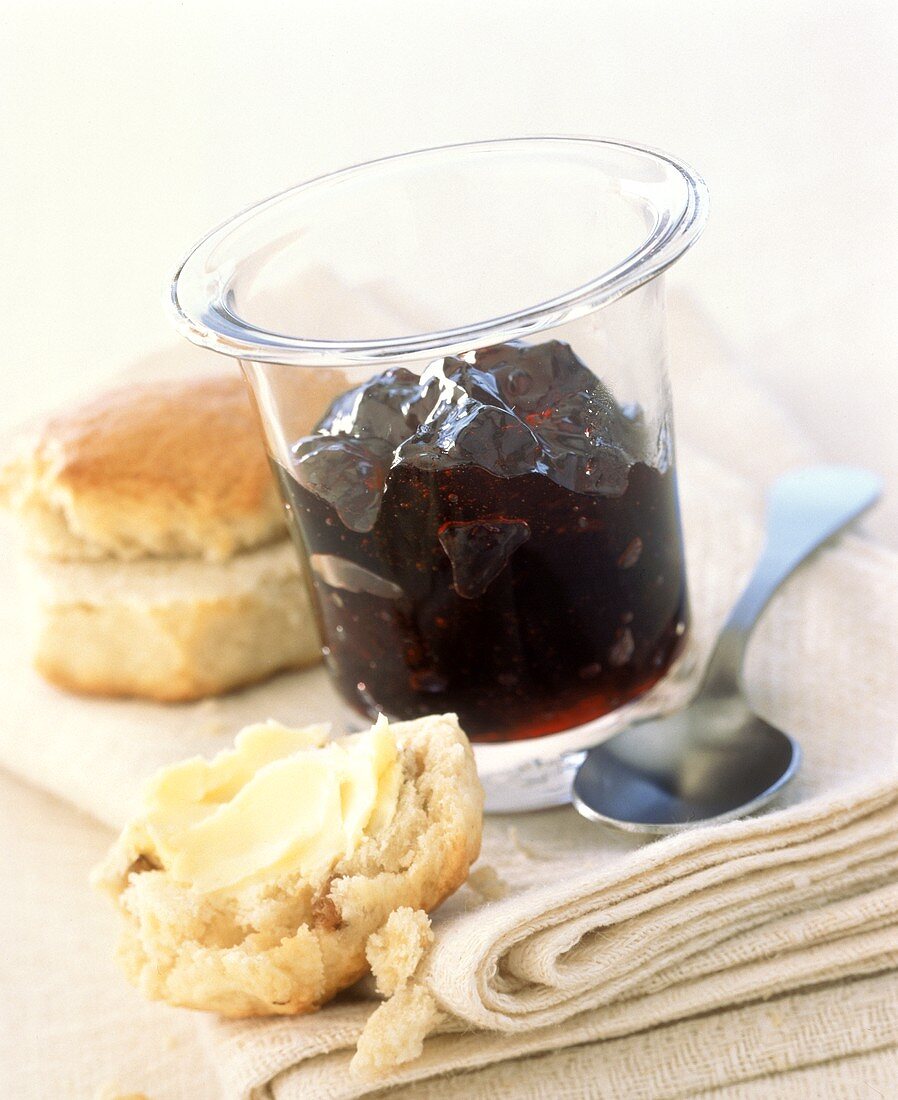 Blueberry and cinnamon jelly in jar, scones beside it