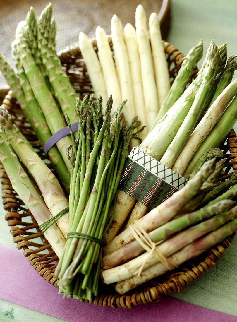 Still life with various types of asparagus in a basket