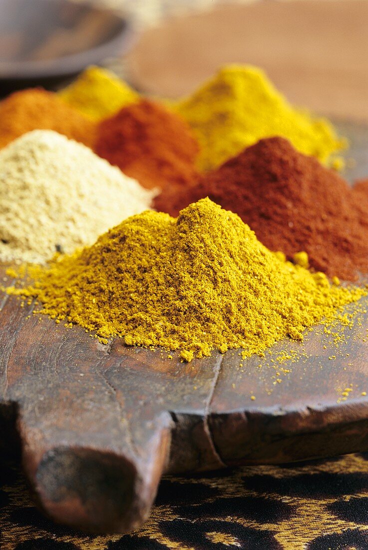 Various spices on a wooden board