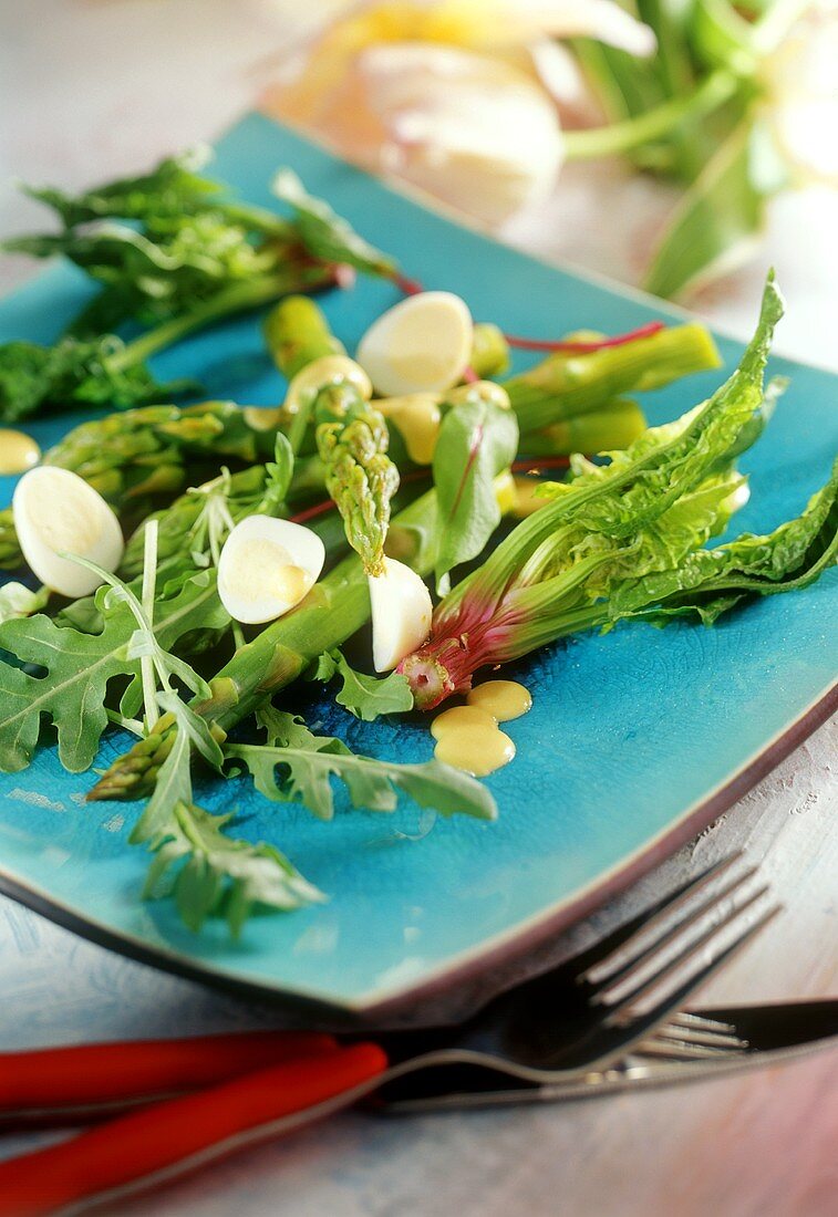 Green asparagus salad with quail's eggs and spinach