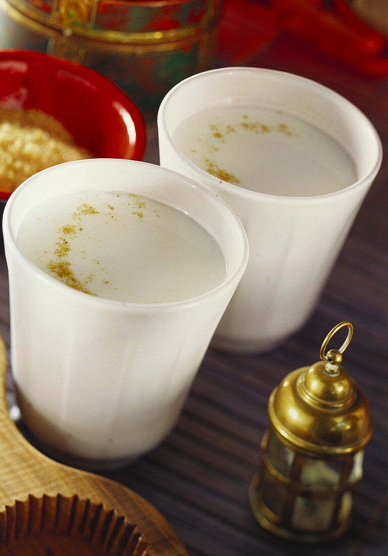 Two beakers of lassi with ground ginger (India)