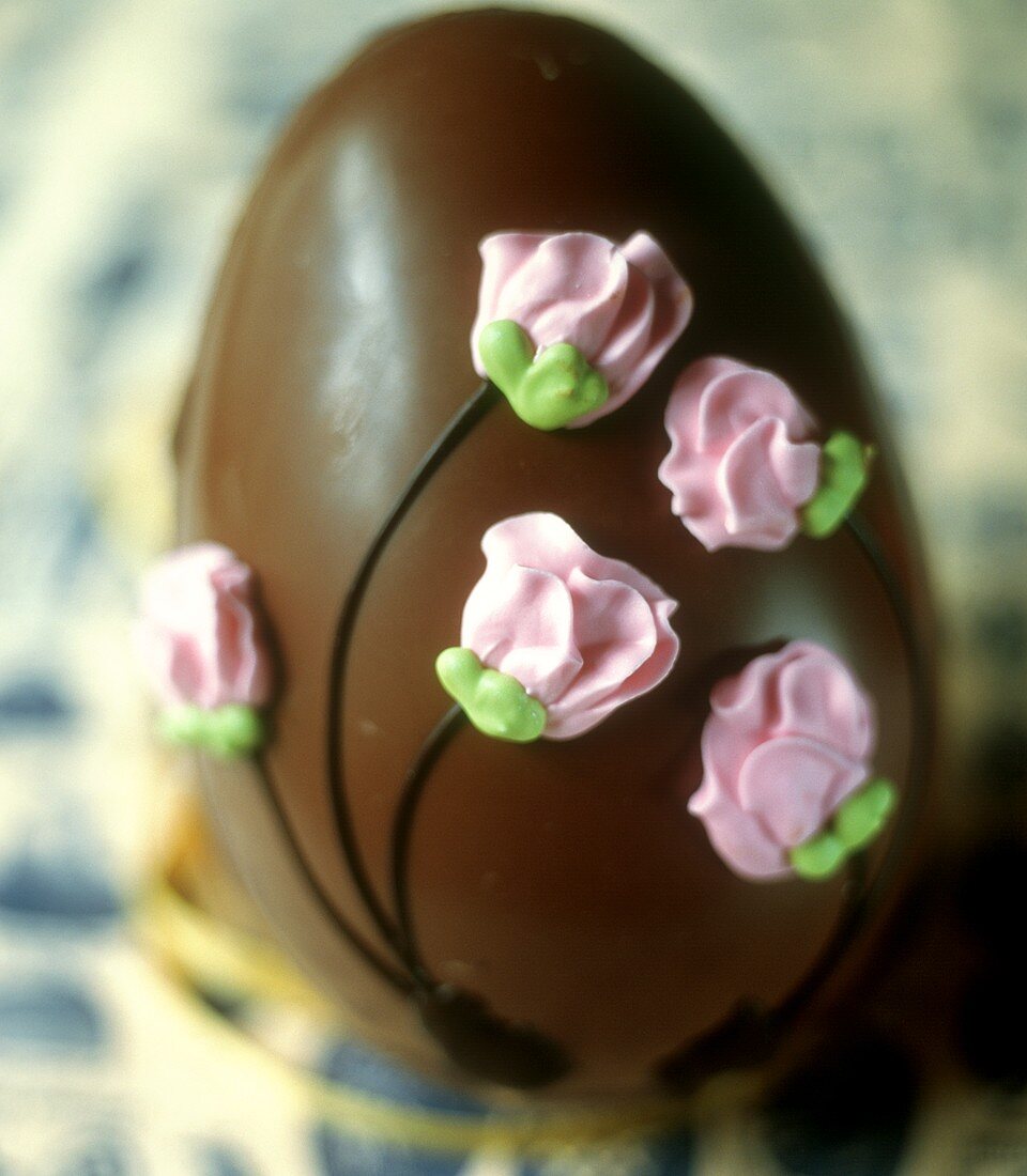 Chocolate Easter egg decorated with iced flowers
