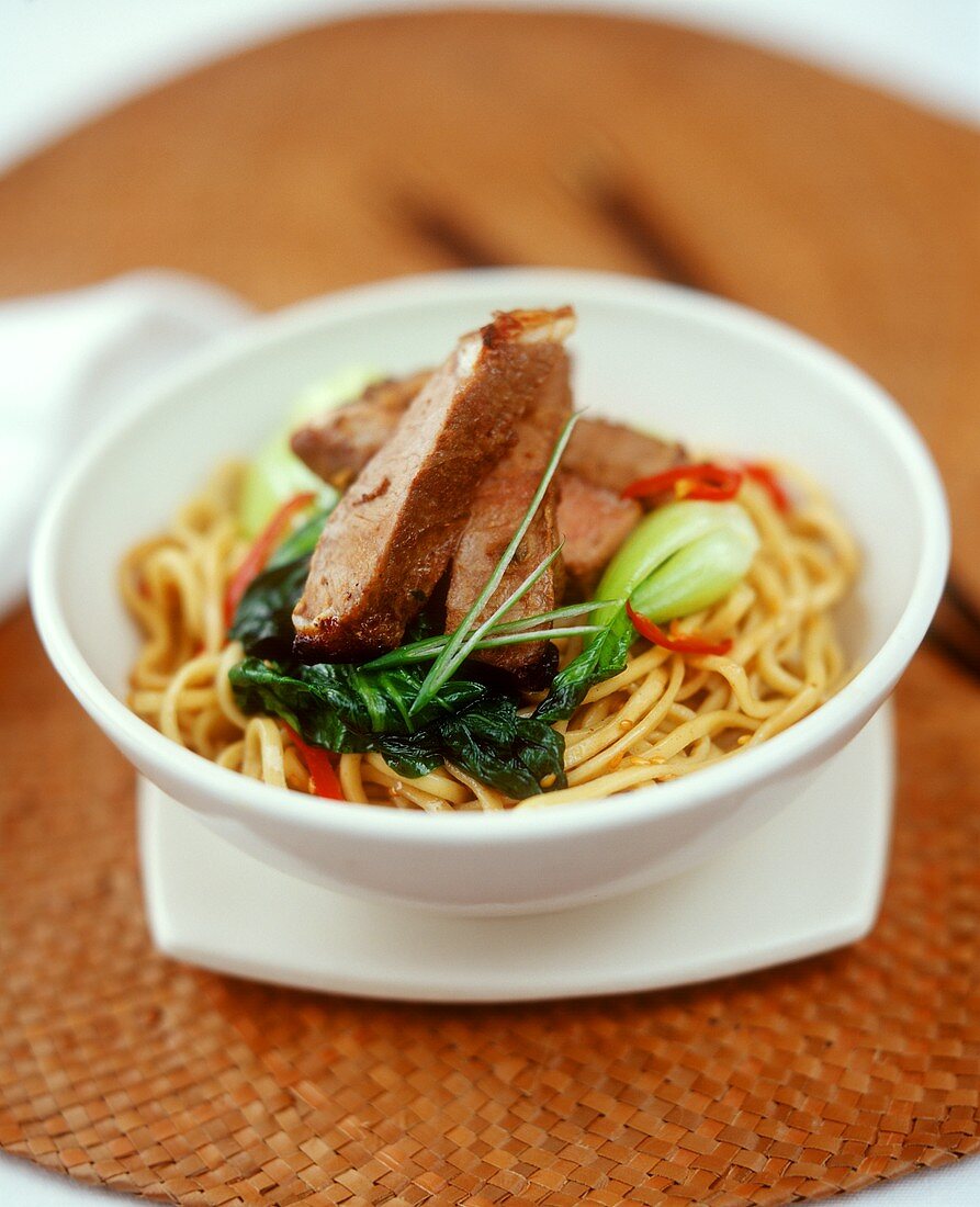 Lamb fillet with chili and pak choi on Chinese egg noodles