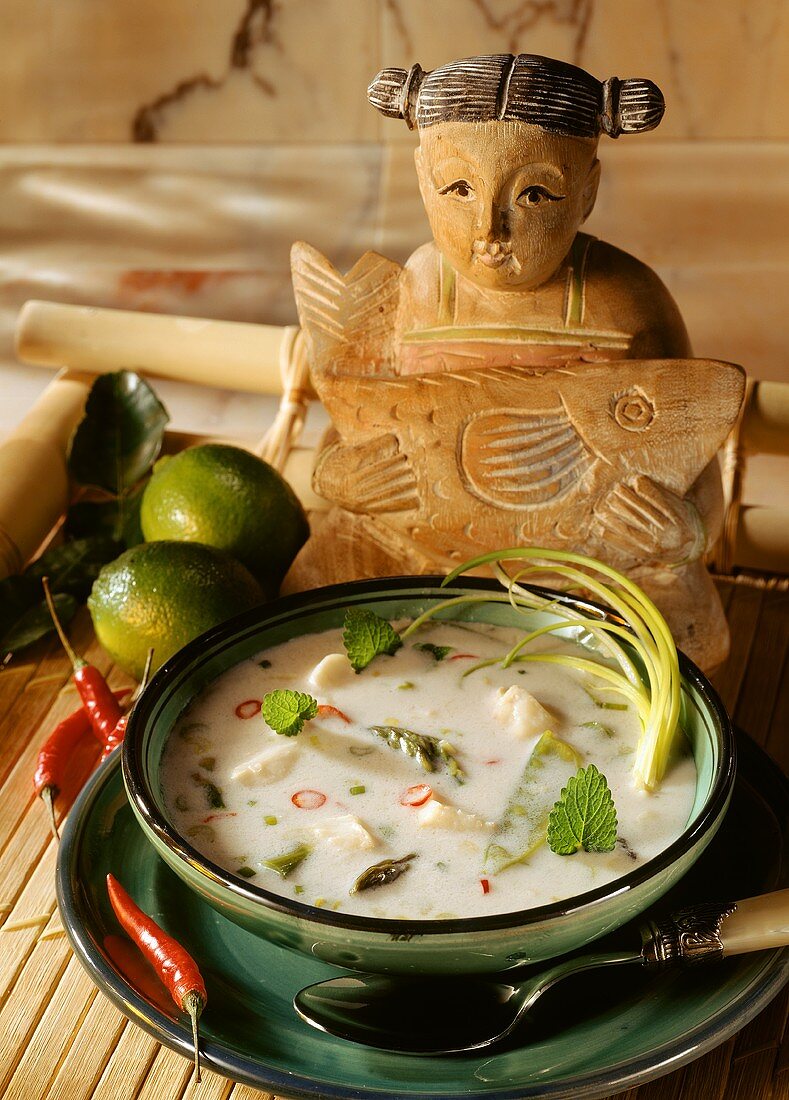 Lemon and coconut soup with fish and asparagus