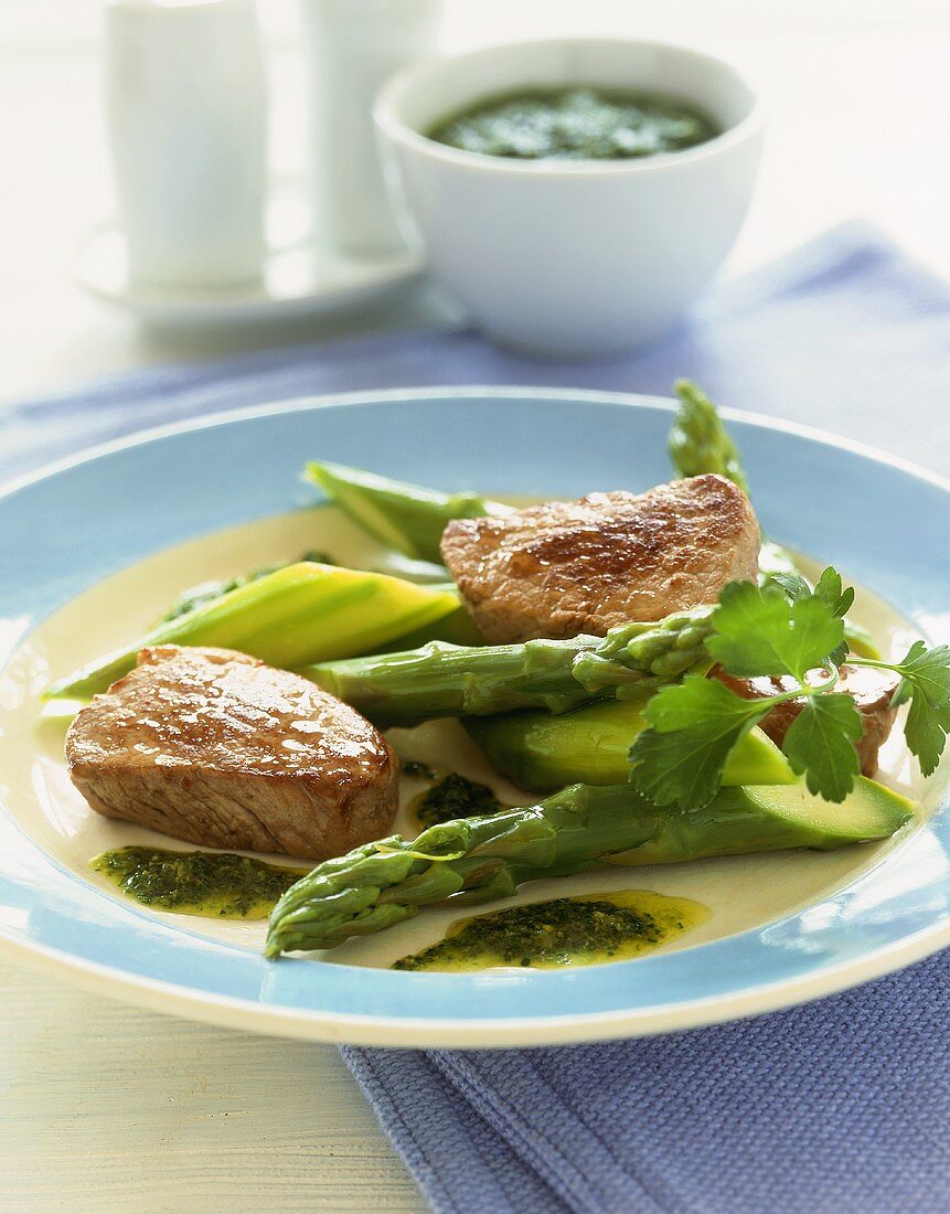 Pork medallions with green asparagus and salsa verde