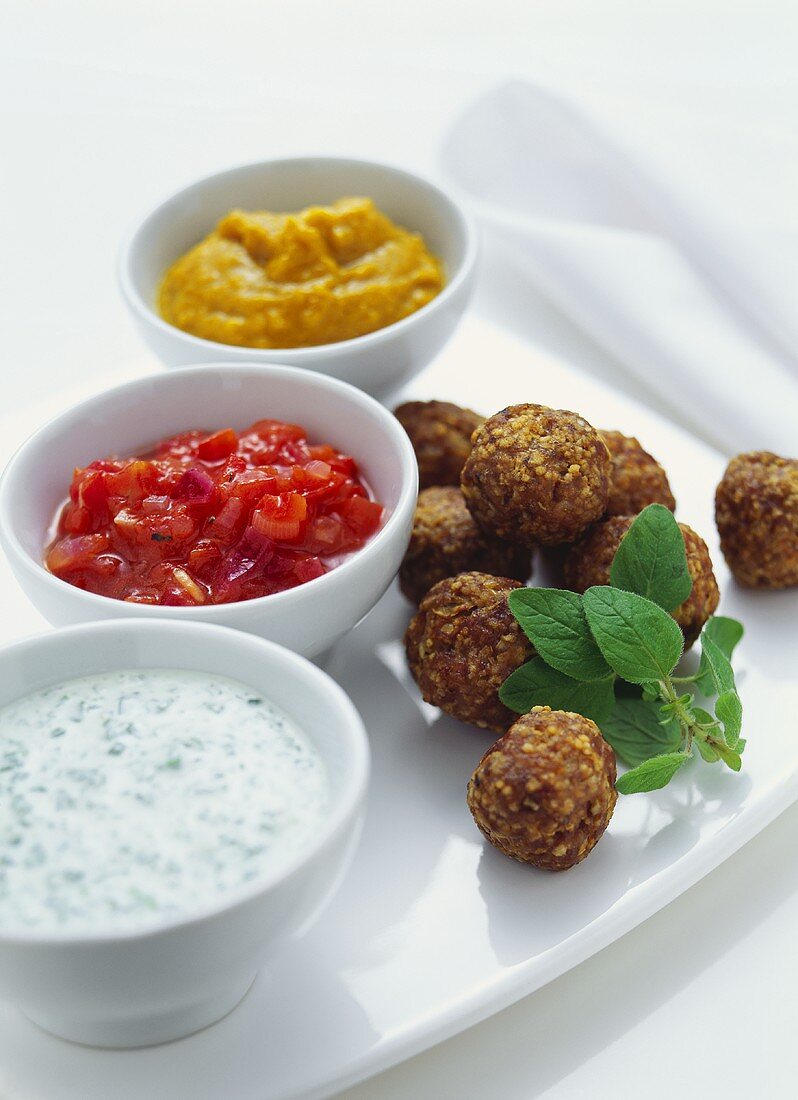 Meat and couscous balls with three different dips