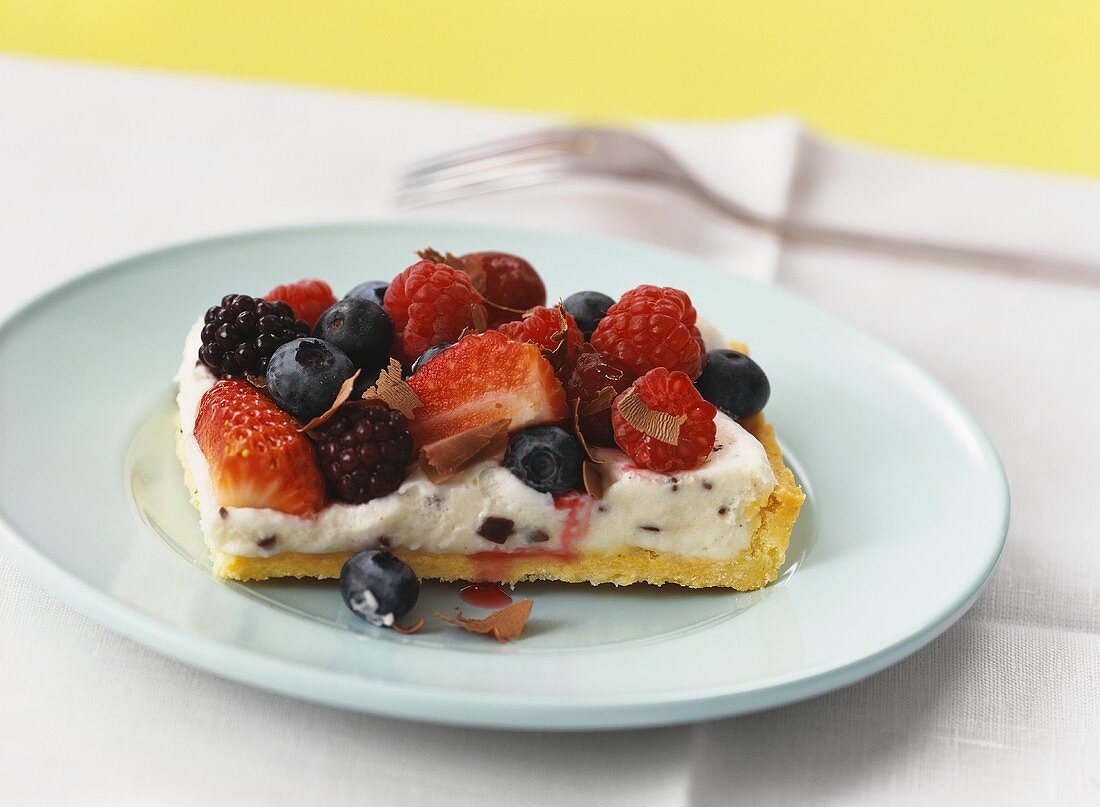 A piece of berry stracciatella cake on green plate