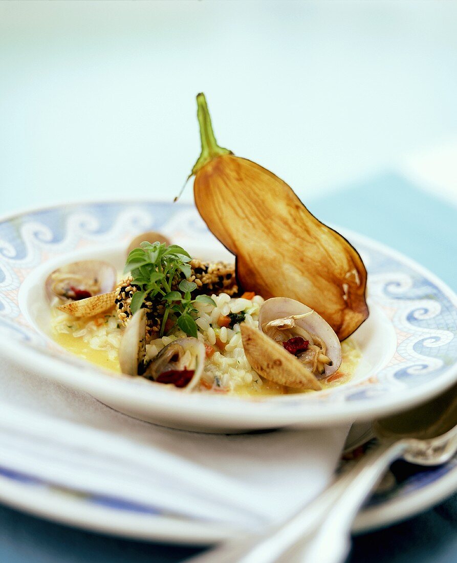 Mussel risotto with guinea fowl breast in sesame coating