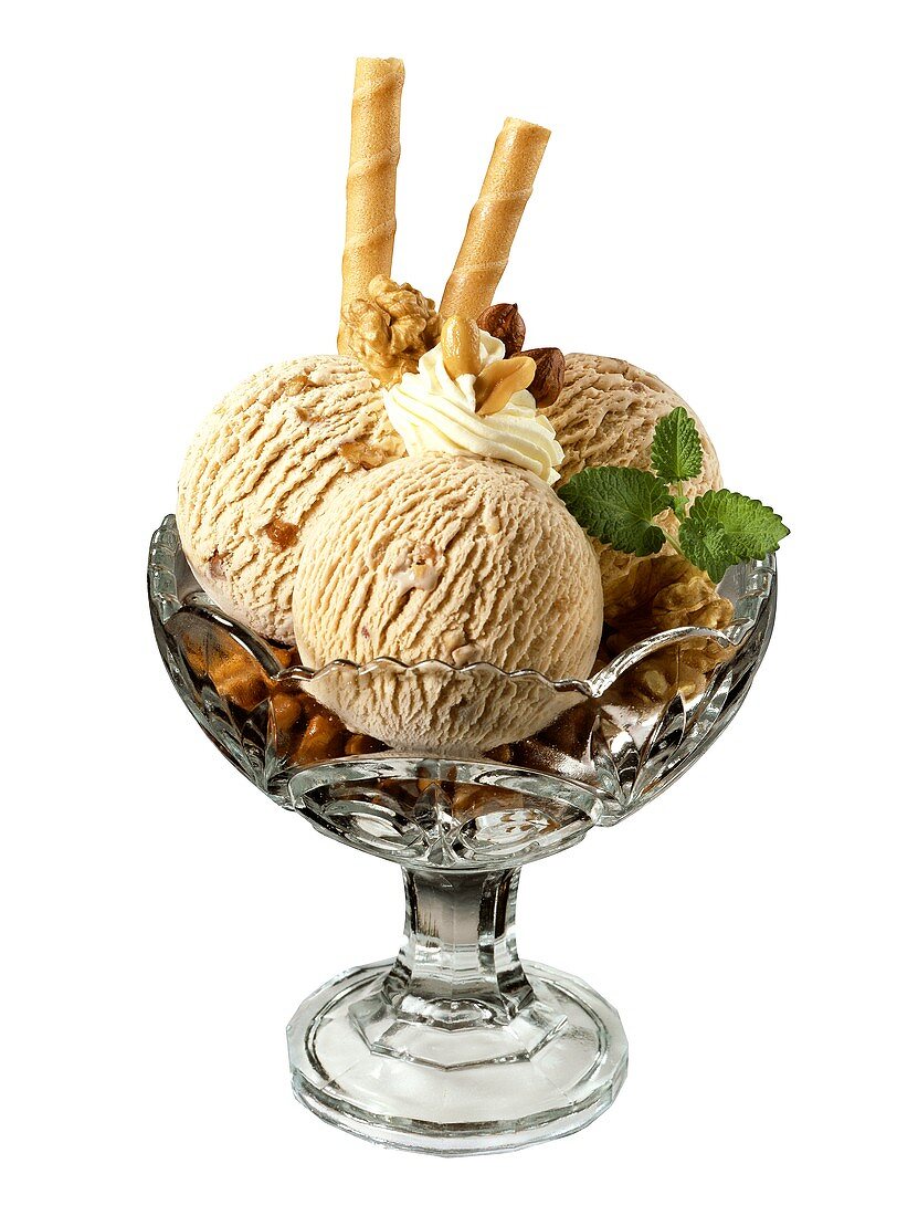 Walnut ice cream with cream and wafer rolls in sundae glass