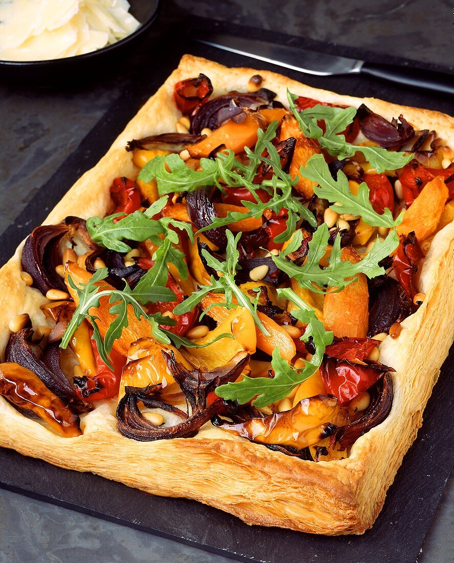 Vegetable pizza with rocket on baking tray