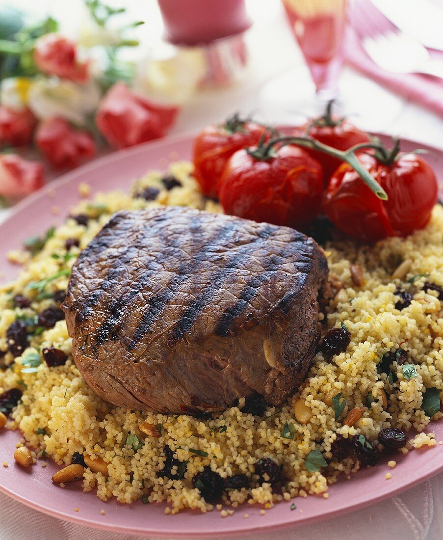 Barbecued filled steak on couscous with raisins & pine nuts