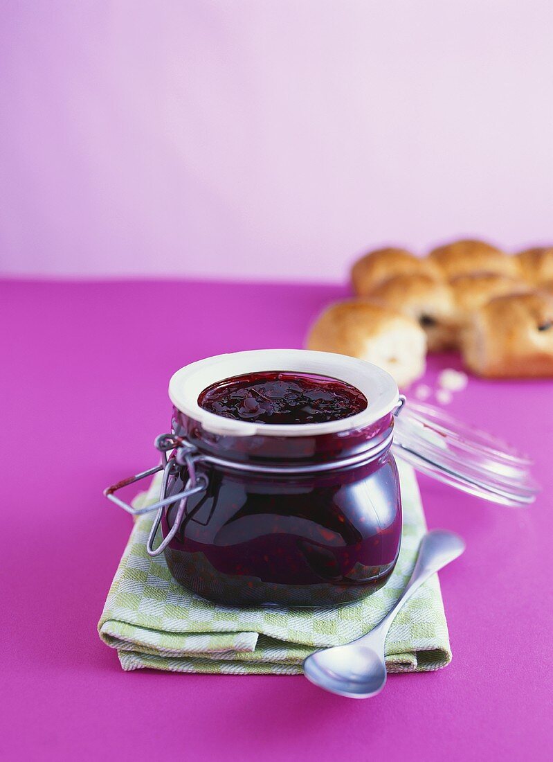 Blackberry jam with star anise, raisin buns behind