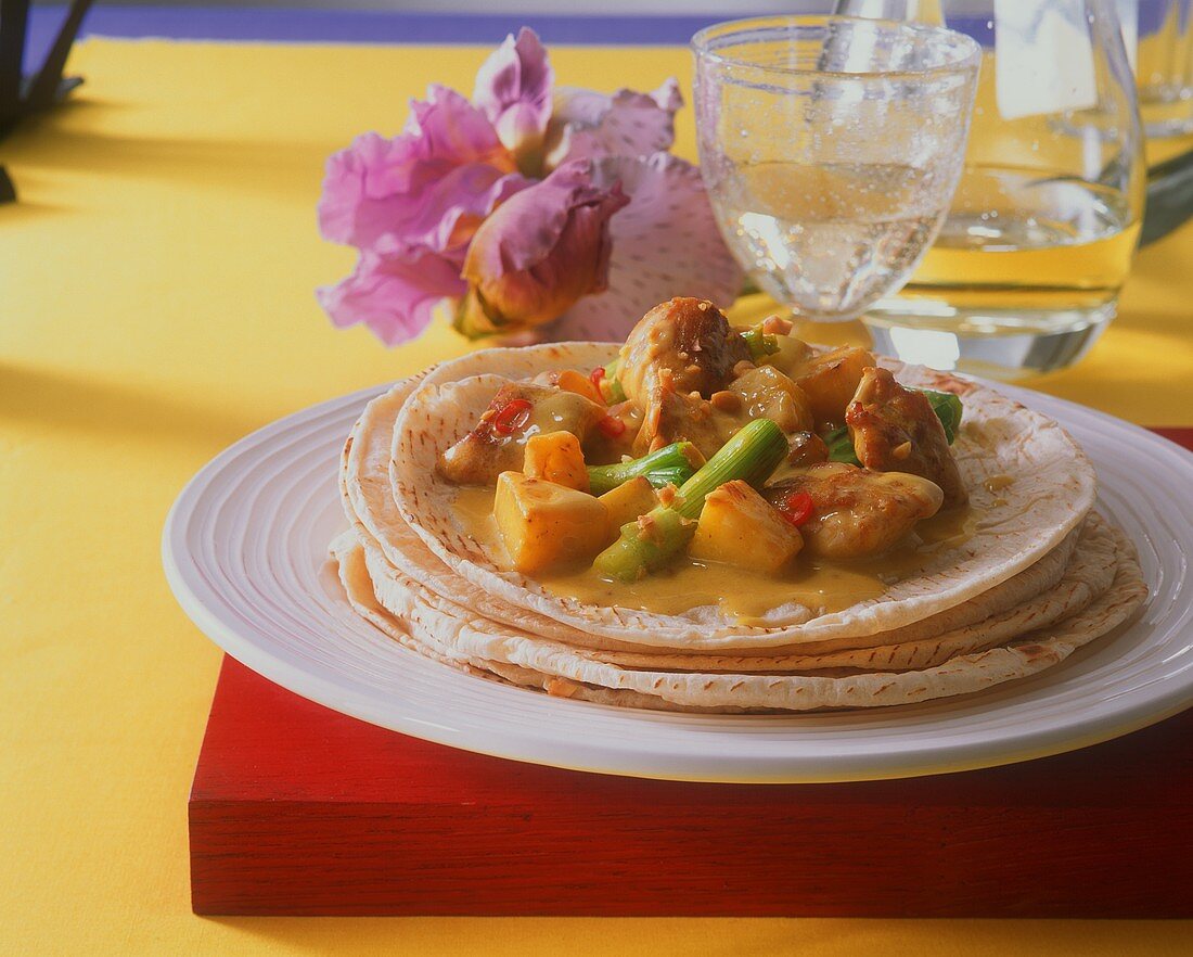 Chicken curry on roti (Indian flatbread)