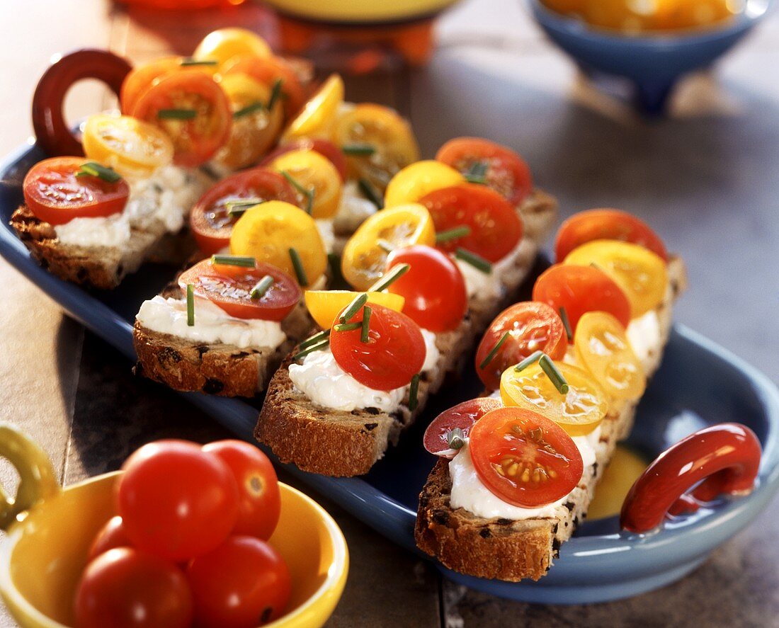 Olive bread topped with soft cheese & cocktail tomatoes