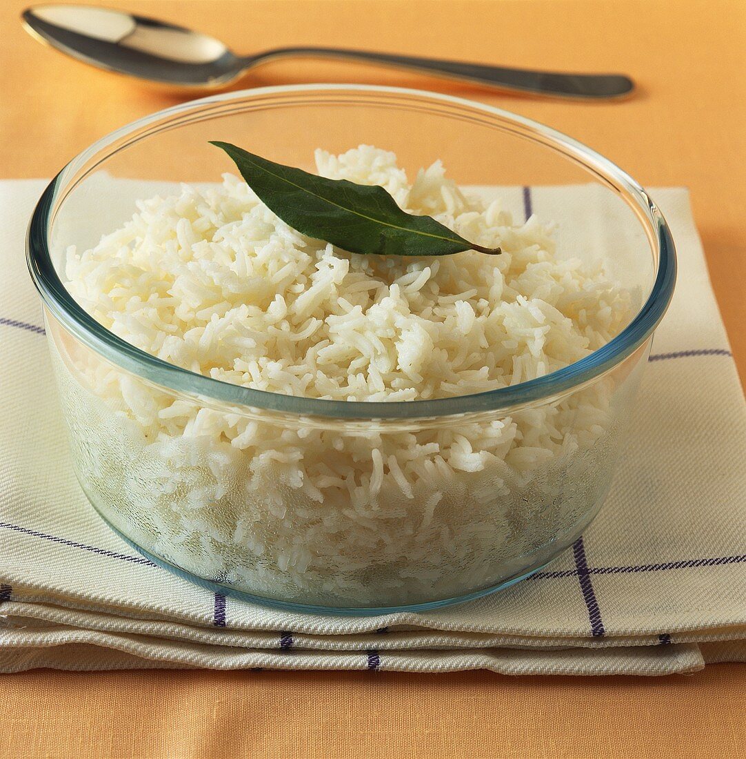 Cooked basmati rice in a glass dish on kitchen cloth