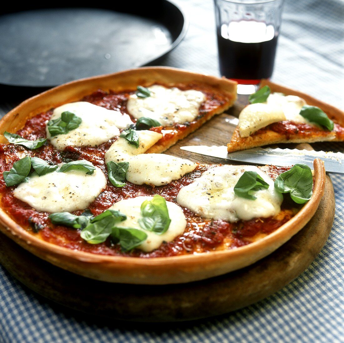 Pizza Margherita on a wooden plate
