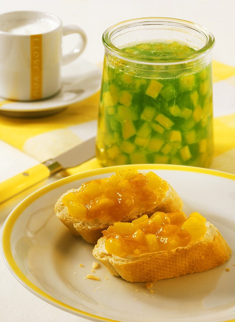 Bread with mango & melon jam, jar of mango & kiwi fruit jelly