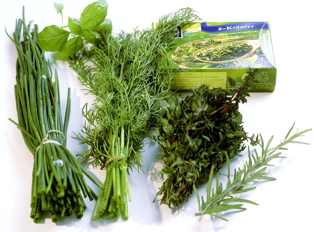 Still life with bunches of herbs and frozen herbs