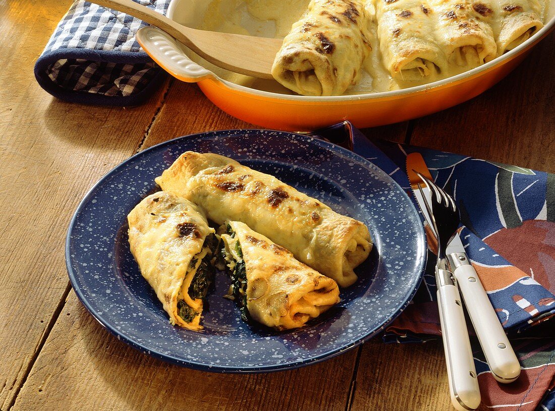 Baked pancake rolls with spinach filling