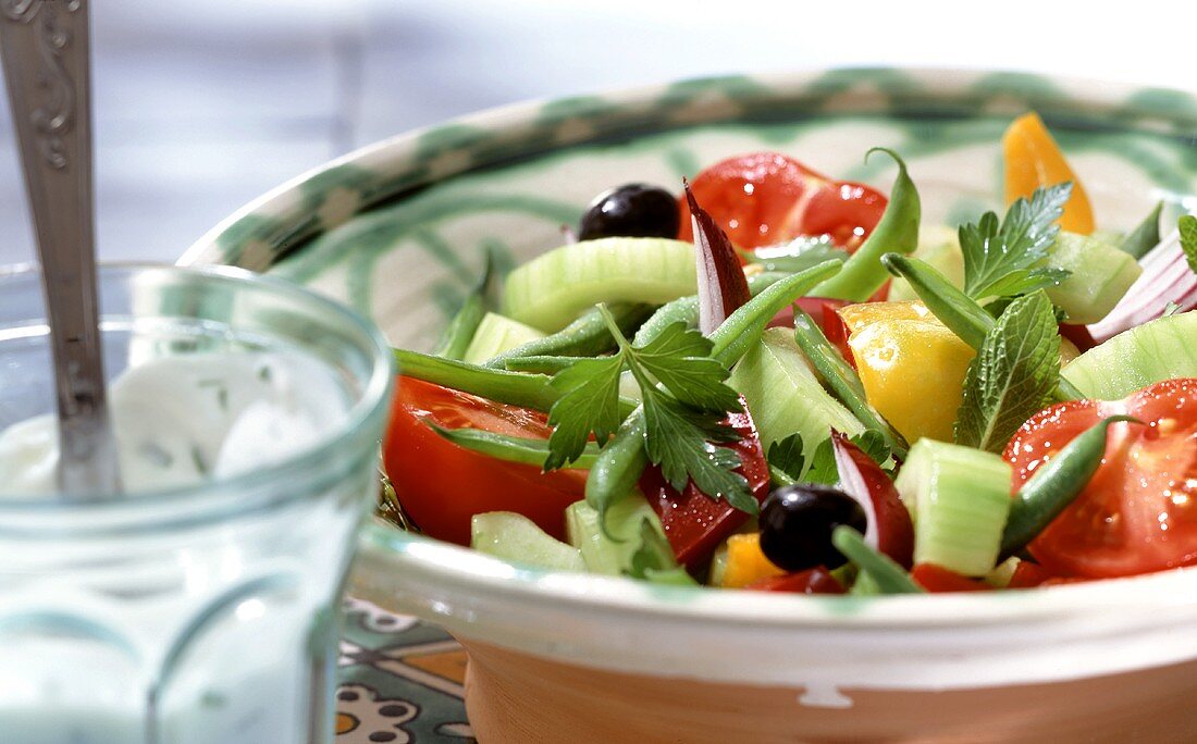 Colourful vegetable salad with minted yoghurt dressing