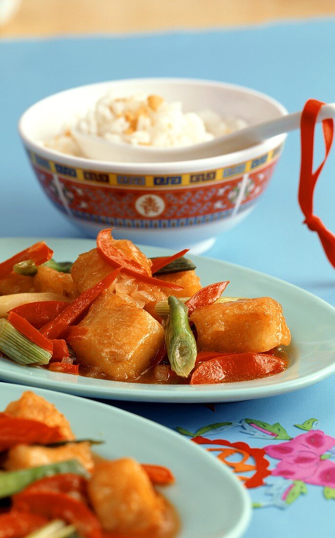 Sweet and sour fish in batter, with rice and peanuts