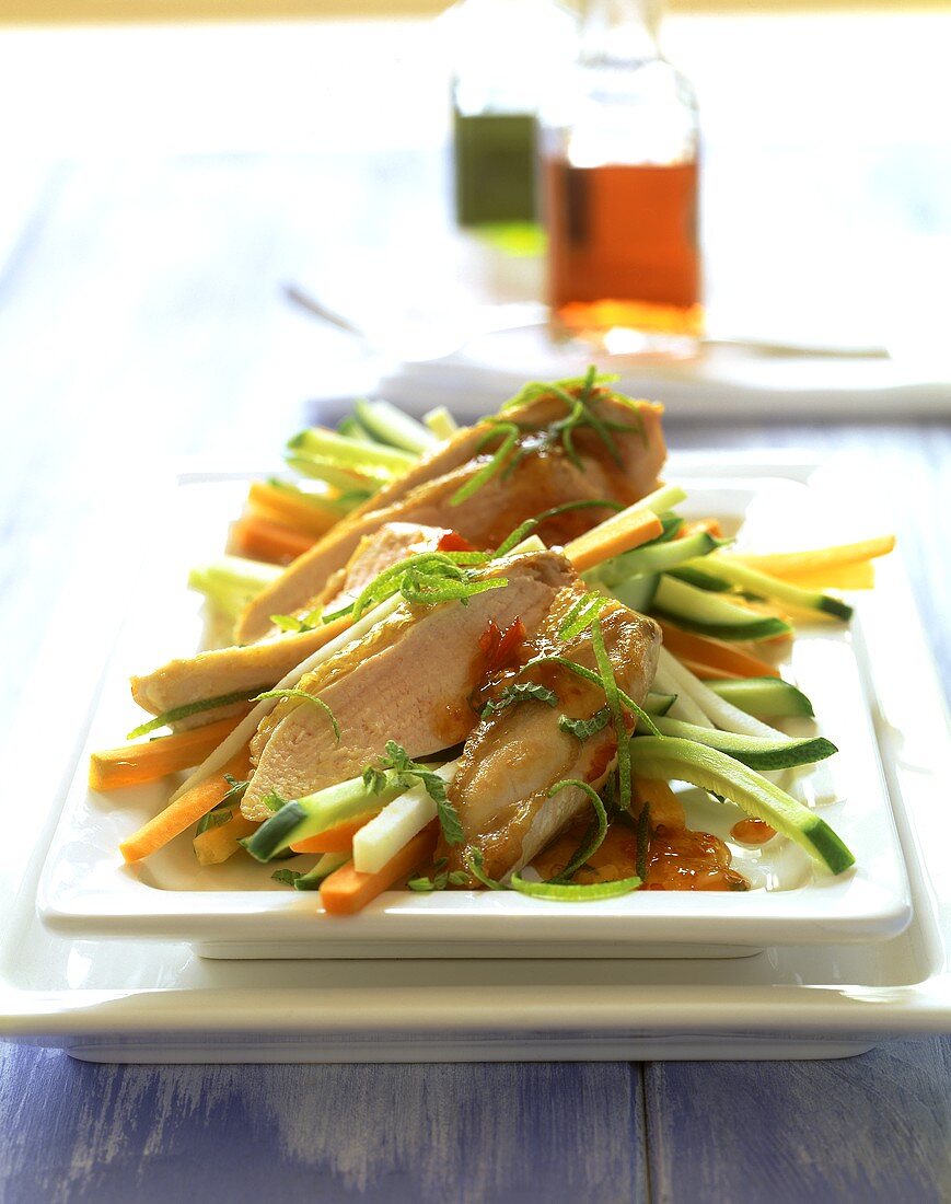 Raw carrot and cucumber salad with sliced chicken breast