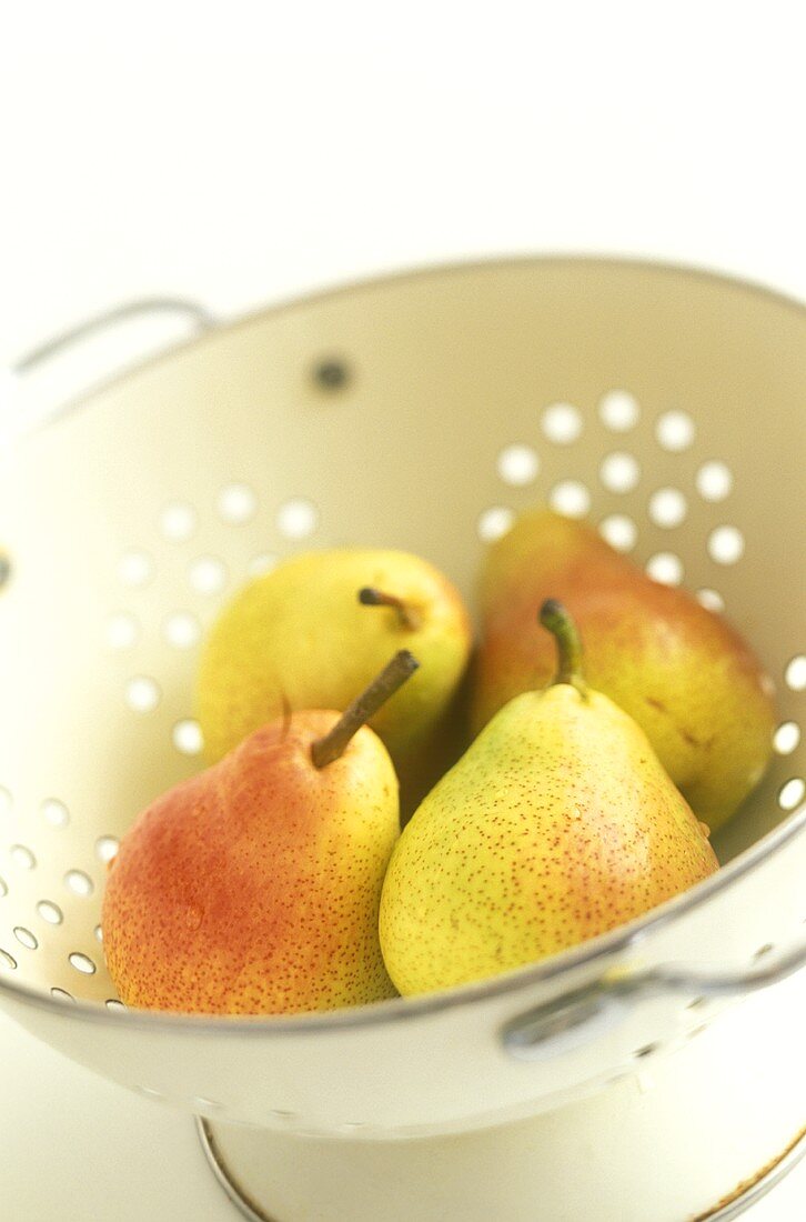 Freshly washed pears in a sieve