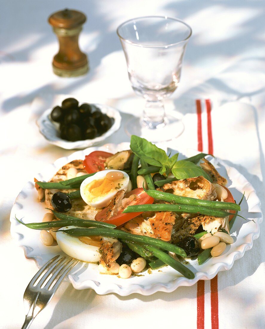 Smoked fish salad with vegetables, bread and egg