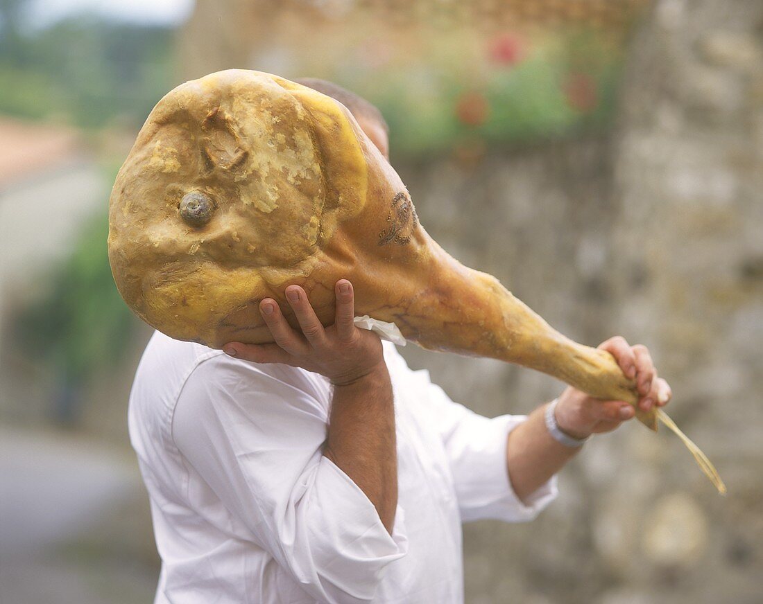 Man carrying San Daniele ham (with seal of quality)