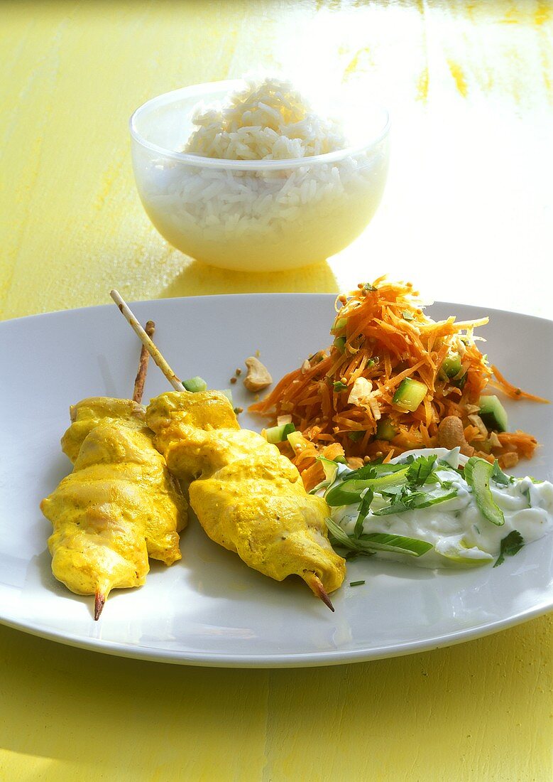 Chicken kebabs with turmeric, yoghurt dip, spicy carrot salad