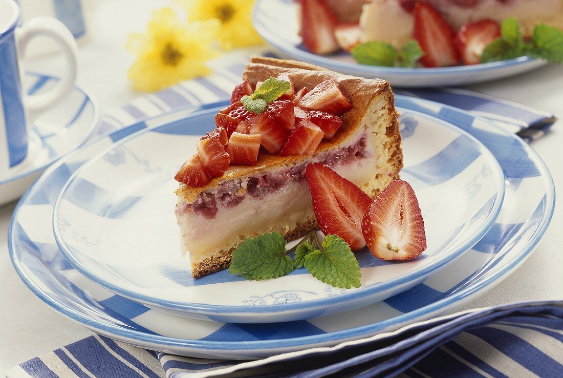 A piece of quark cake with strawberries