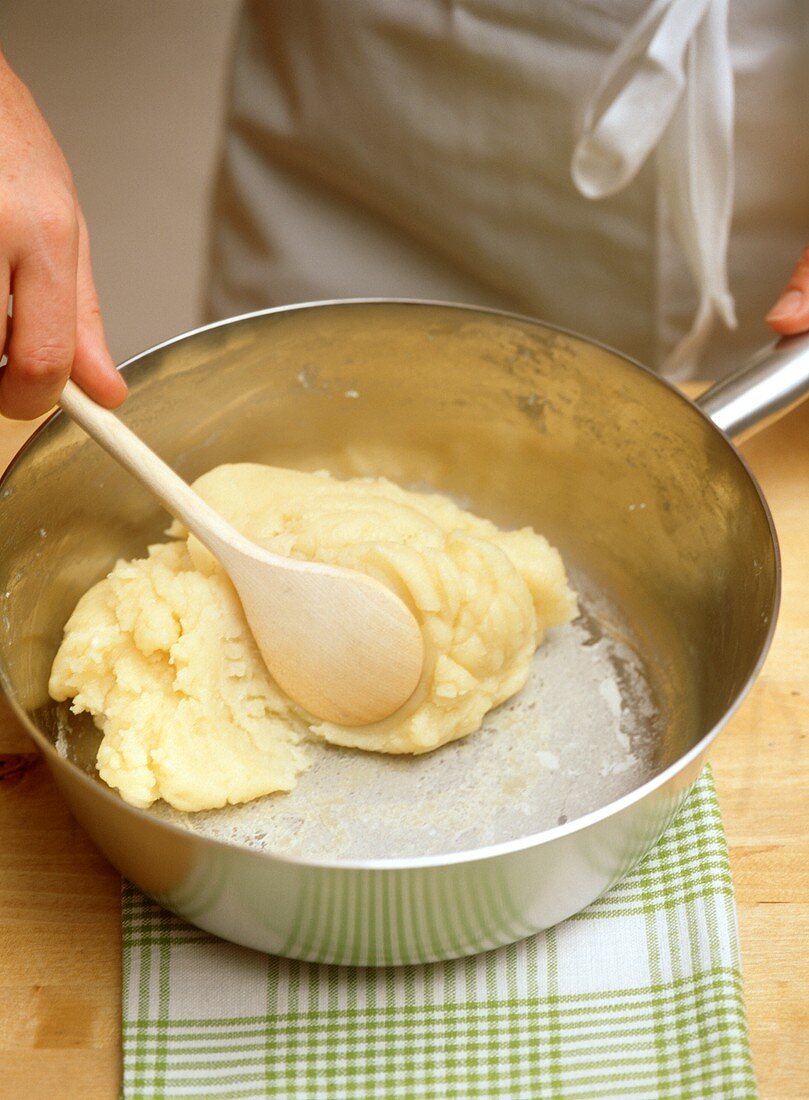Making choux pastry (beat until it comes away from side of pan)